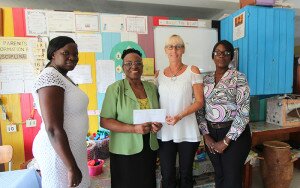 Palm Island Manager, Katie Rosiak (right) hands over a cheque to Stephanie Browne. 